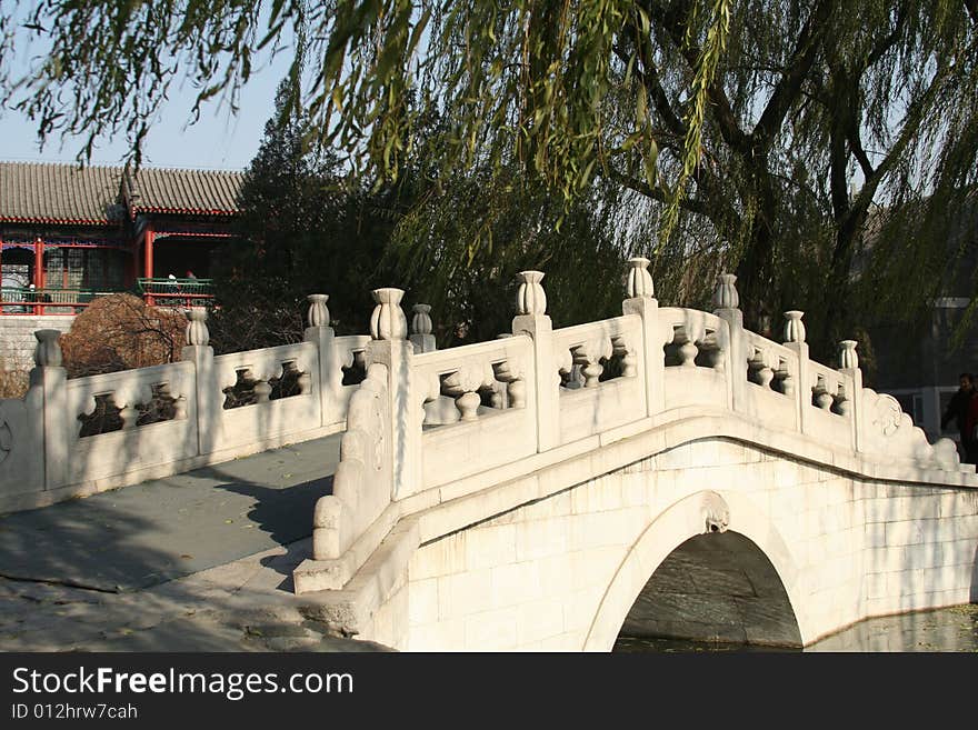 Chinese stone bridge under willow