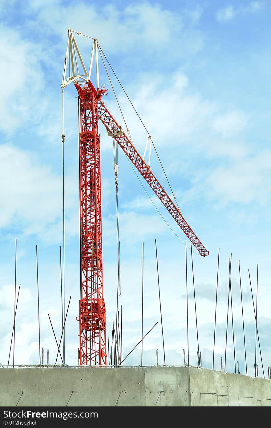 Bright red crane for heavy lifting on a construction site. Bright red crane for heavy lifting on a construction site