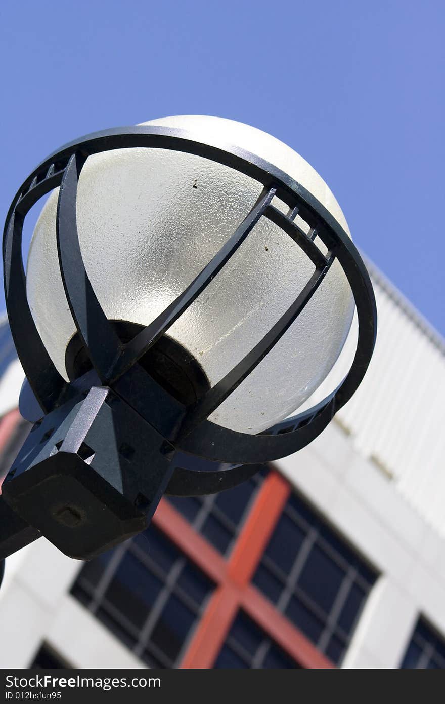 Macro close-up of urban style lantern in downtown Toronto with blue sky