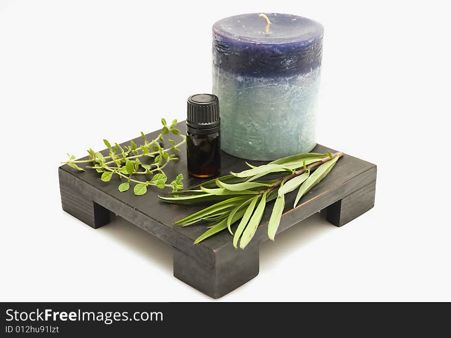 Still life of herbs, mineral oil, and candle. Still life of herbs, mineral oil, and candle