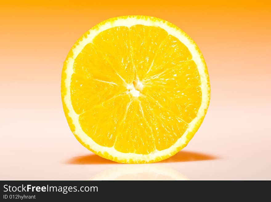 Fresh slice of orange with zesty gradient lighting. Fresh slice of orange with zesty gradient lighting