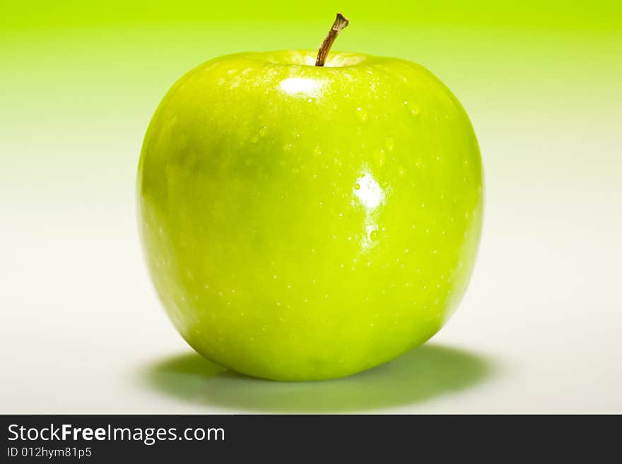 Fresh green apple with fresh gradient lighting and water droplets