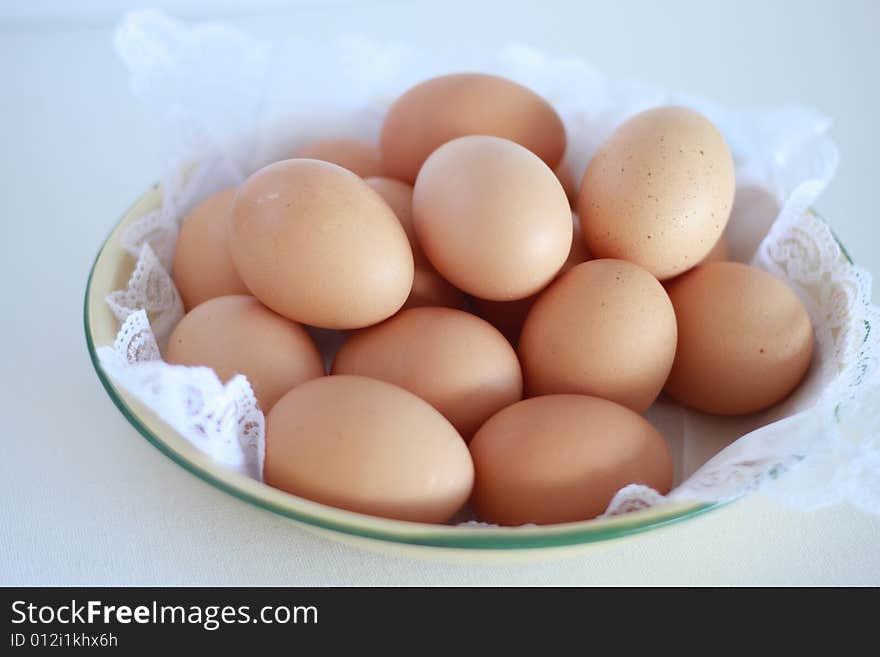 A closeup view of a bowl of fresh farm eggs. A closeup view of a bowl of fresh farm eggs.