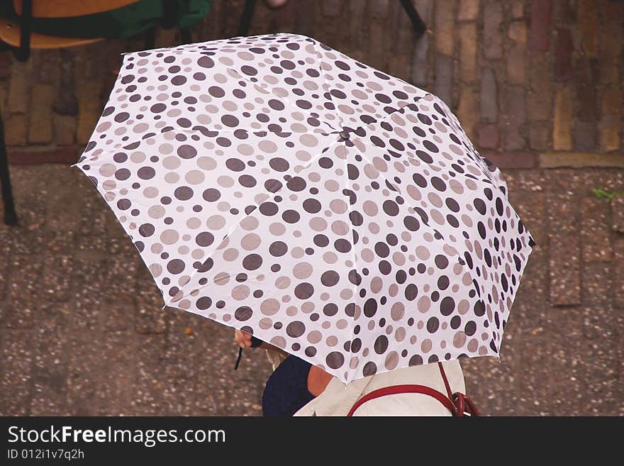 An umbrella with brown and grey spots. An umbrella with brown and grey spots