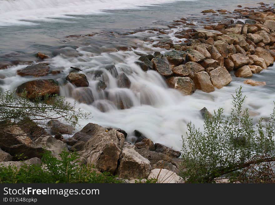 Photo of a small waterfall of a torrent. Photo of a small waterfall of a torrent.