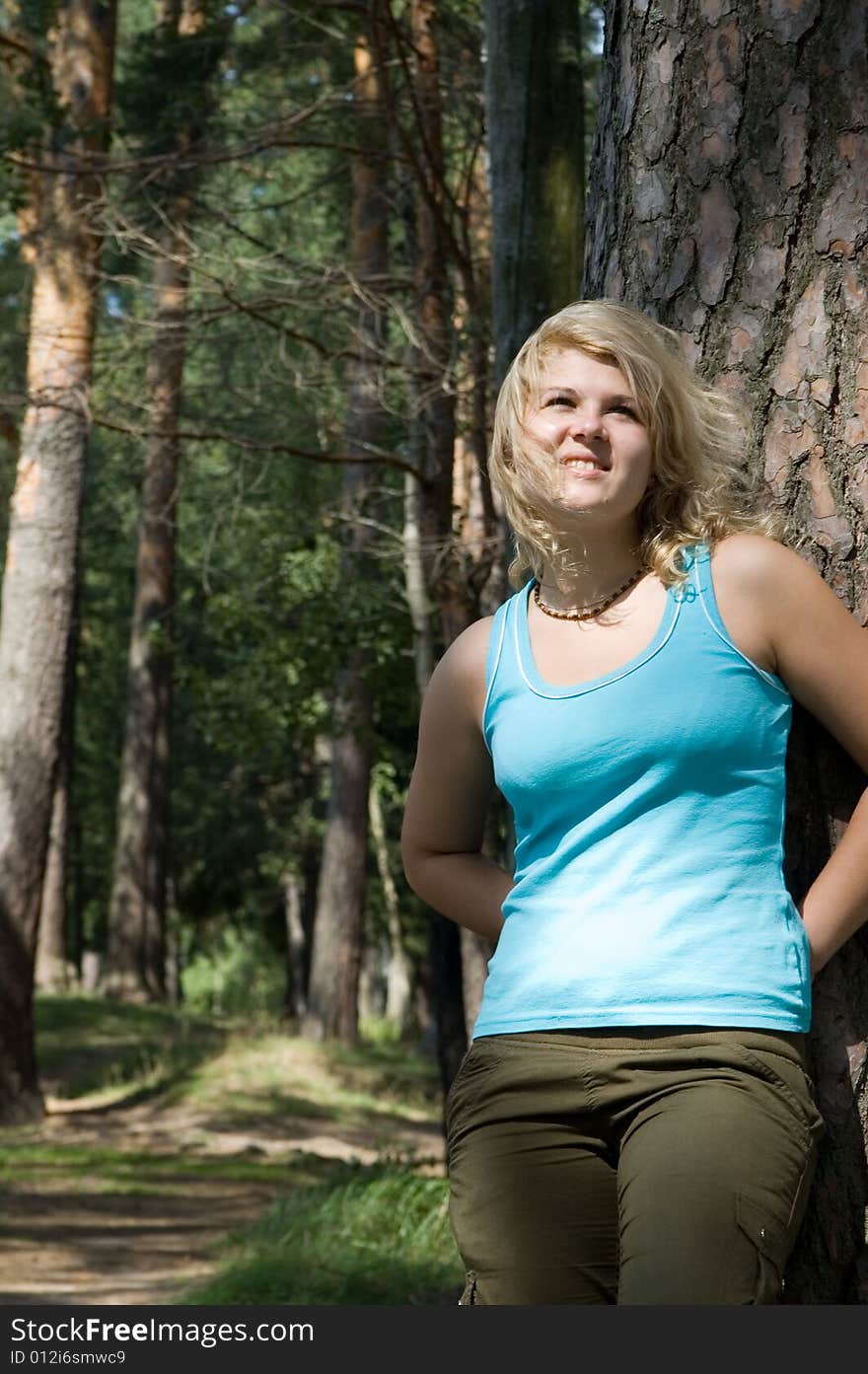 Young beautiful woman in a summer wood