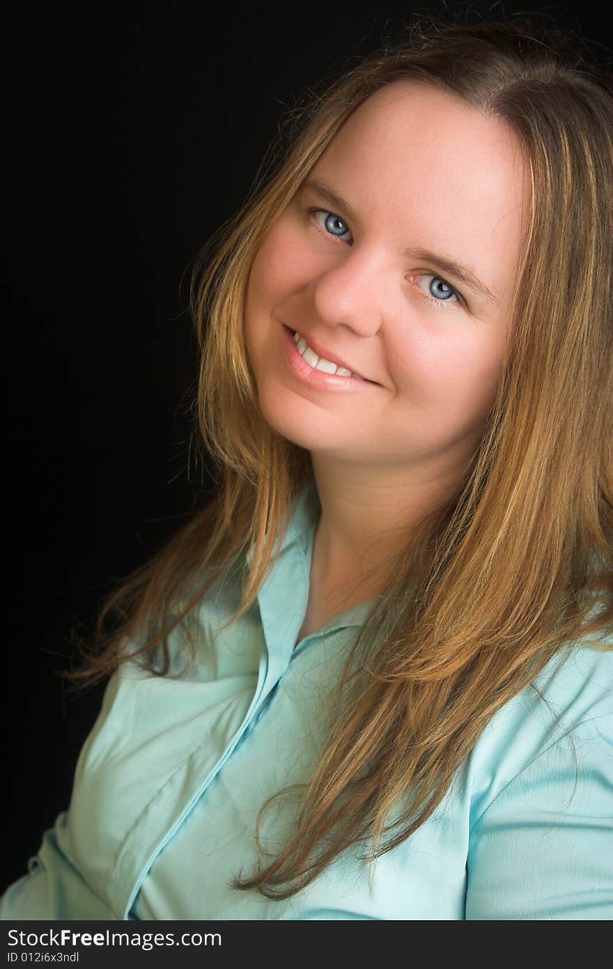 Portrait of an attractive blond woman with blue eyes.