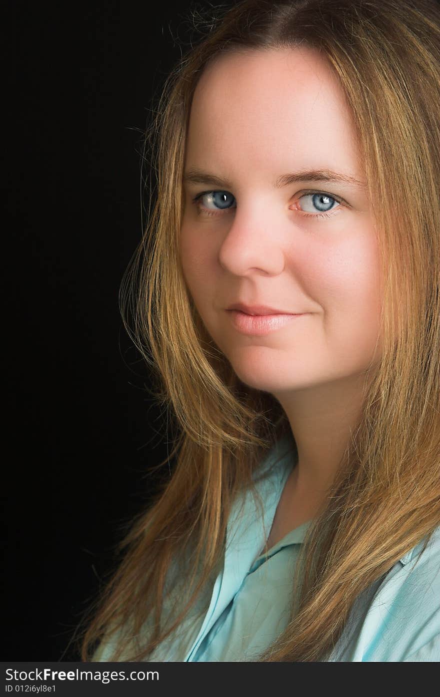 Portrait of an attractive blond woman with blue eyes.