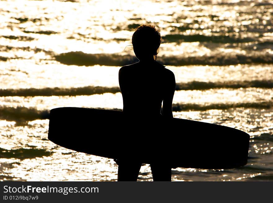 Silhouette of young girl with kite board