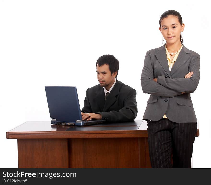 Portrait of beautiful secretary standing infront of her boss table