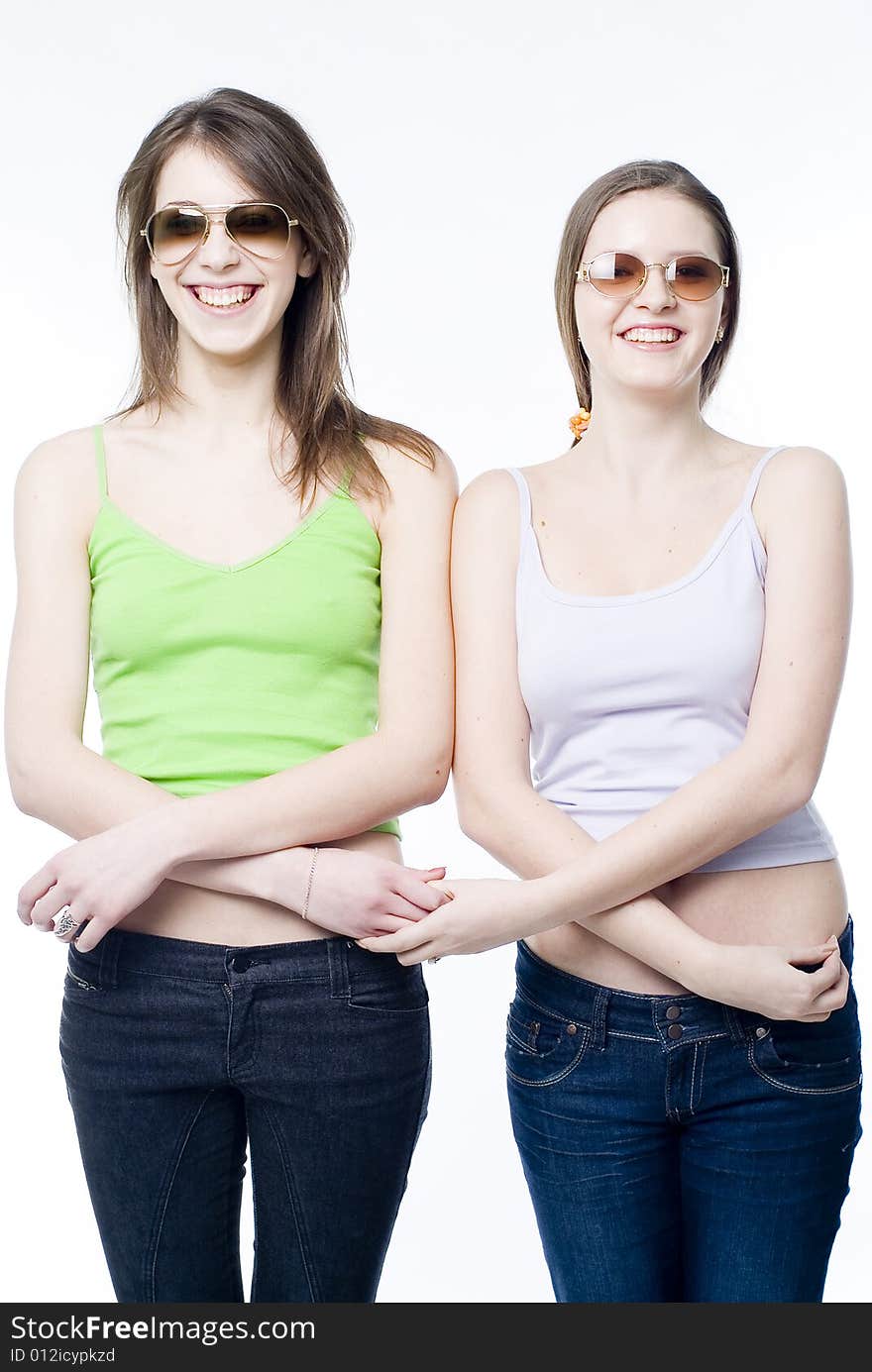 Two young smiling girls on white background. Two young smiling girls on white background