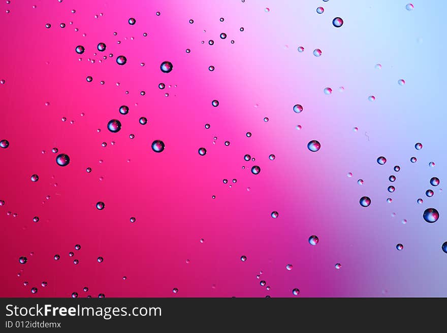 Drops of water on a red, blue background. Drops of water on a red, blue background.