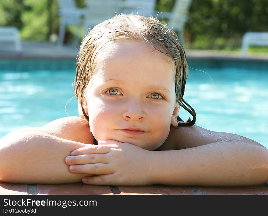 Young girl learning how to swim using a float. Young girl learning how to swim using a float