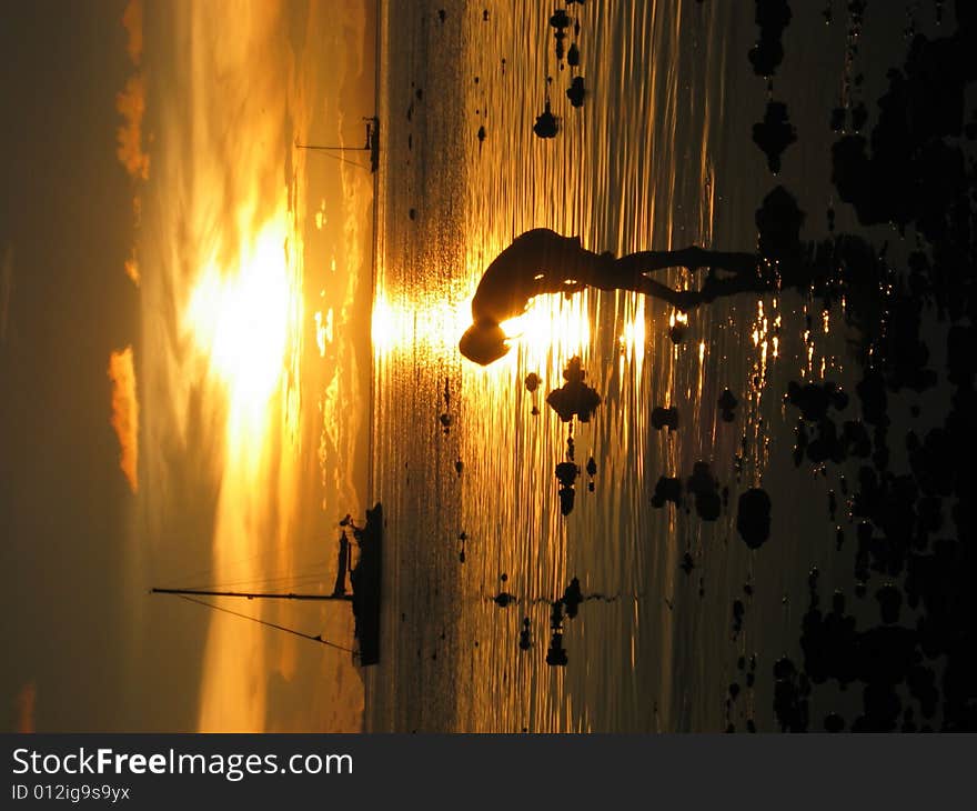 A girl walking on the beach in the golden sunset. A girl walking on the beach in the golden sunset.