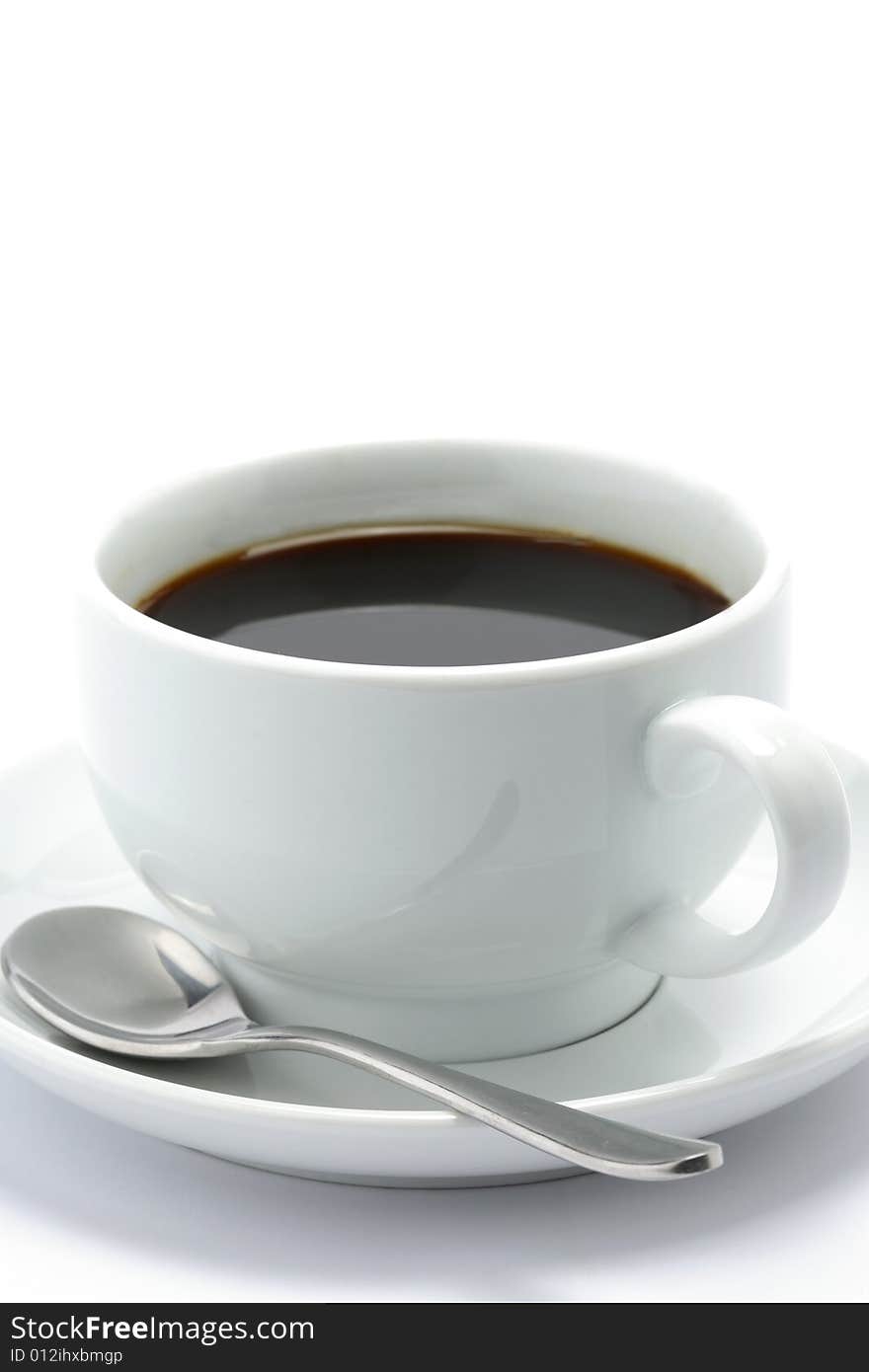 Hot cup of black coffee with a spoon on a white background