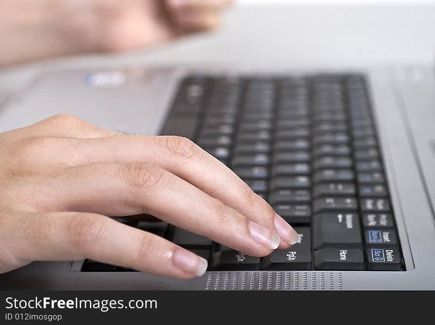 Office woman typing on her laptop keyboard