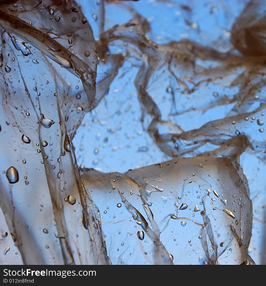 Water drops on a plastic bag in daylight