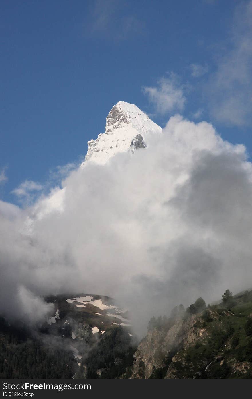 Matterhorn in the morning, emerging from the clouds. Matterhorn in the morning, emerging from the clouds