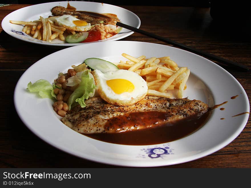 Lunch at Vivo City Singapore, we got the Sauced Grilled Fish with french fries, fried egg, some beans and veggies. Lunch at Vivo City Singapore, we got the Sauced Grilled Fish with french fries, fried egg, some beans and veggies.