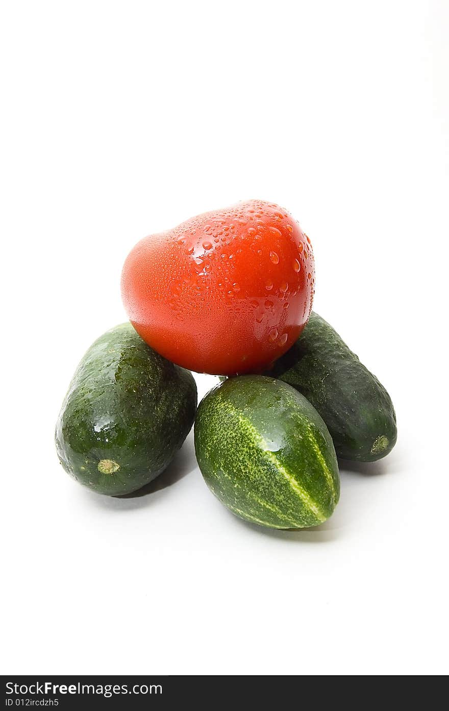 Cucumbers and tomato on white background