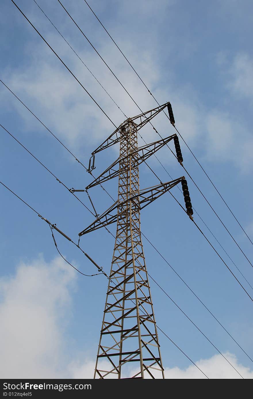 Electrical pylon on background of blue sky and clouds