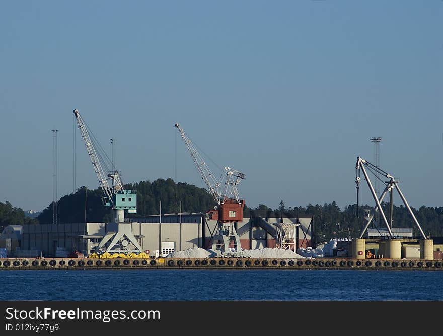 Industrial harbour with cranes and warehouse facilities.