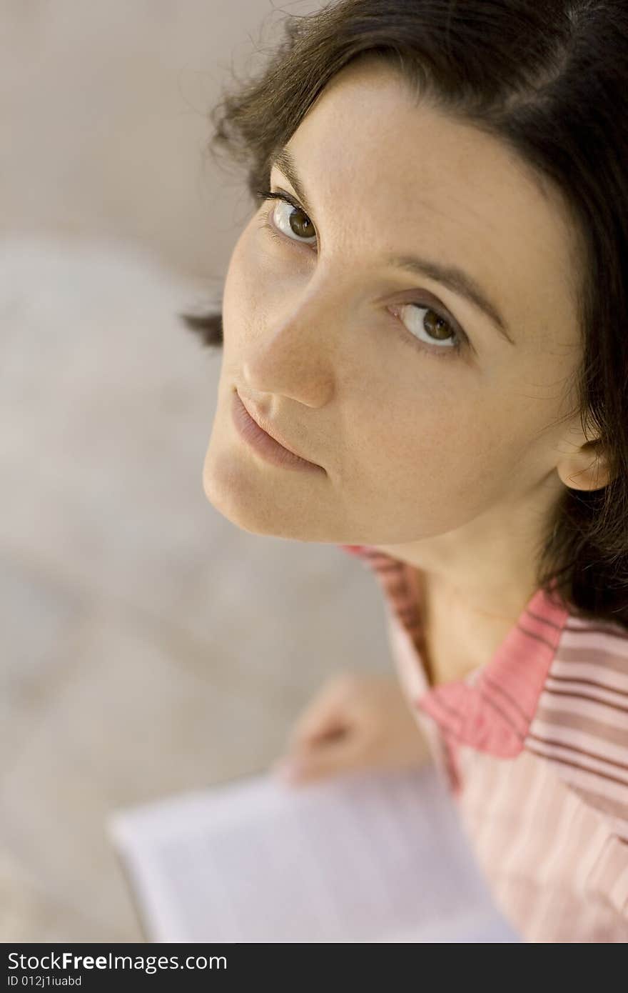 Close up portrait of young woman with a book