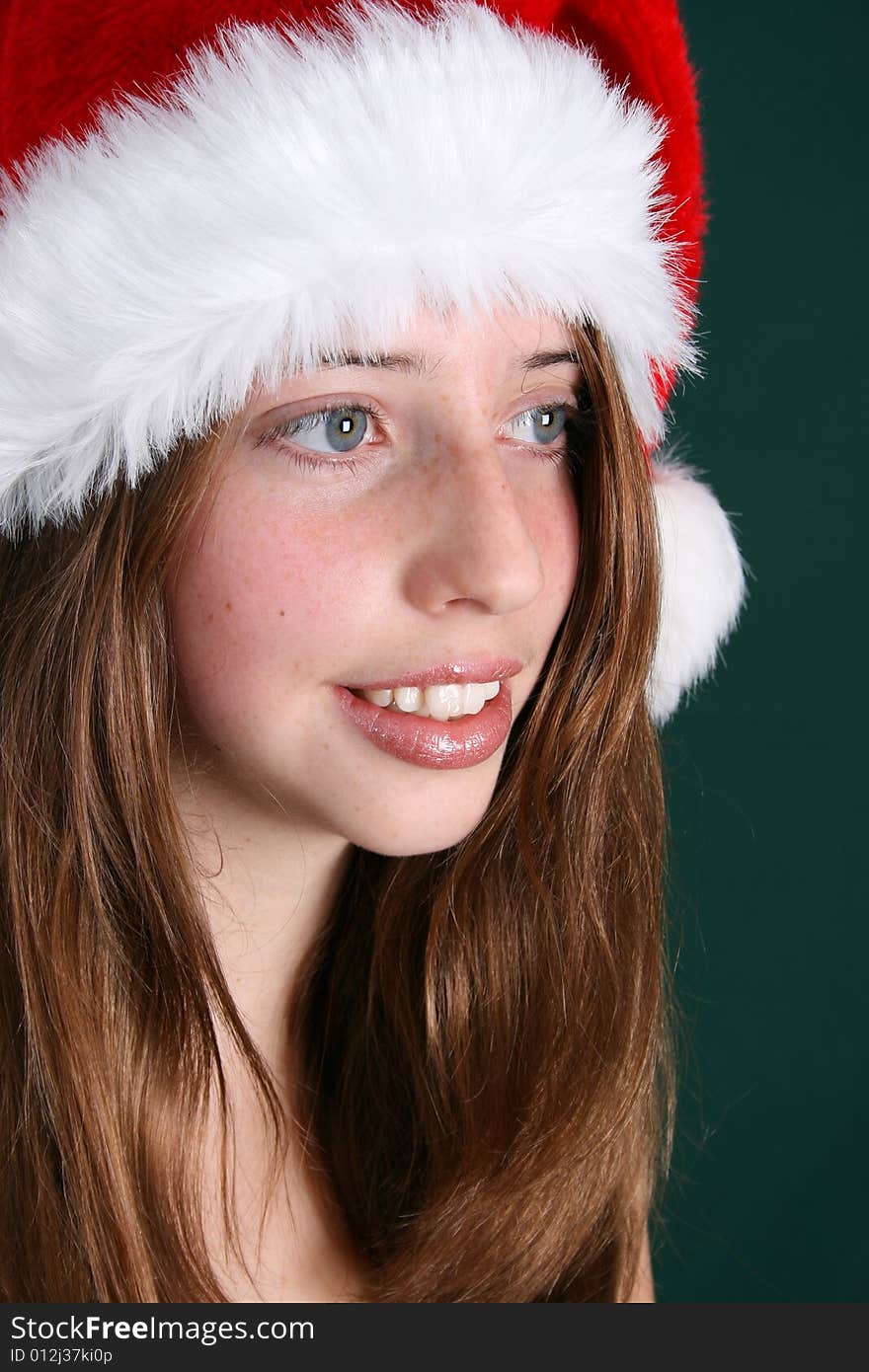 Brunette Teenager wearing a fluffy christmas hat