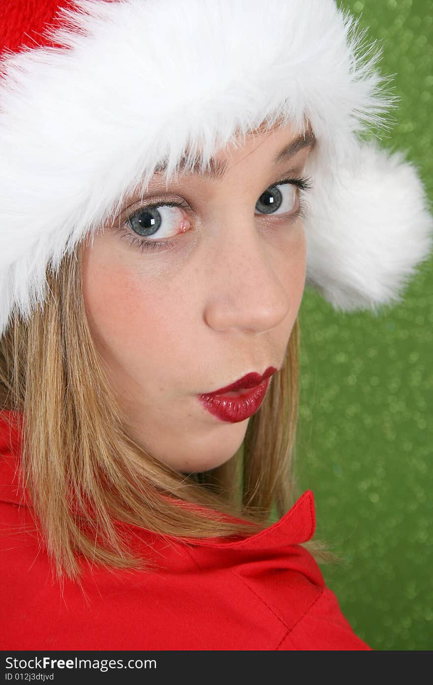 Teenager with red lips wearing a christmas hat. Teenager with red lips wearing a christmas hat