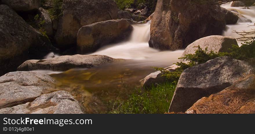 A bend in a rocky mountain river rushing with spring runoff. A bend in a rocky mountain river rushing with spring runoff.