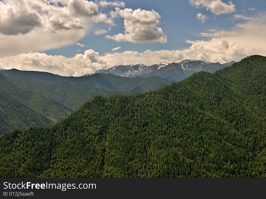 Remote glacier and clouds in mountains