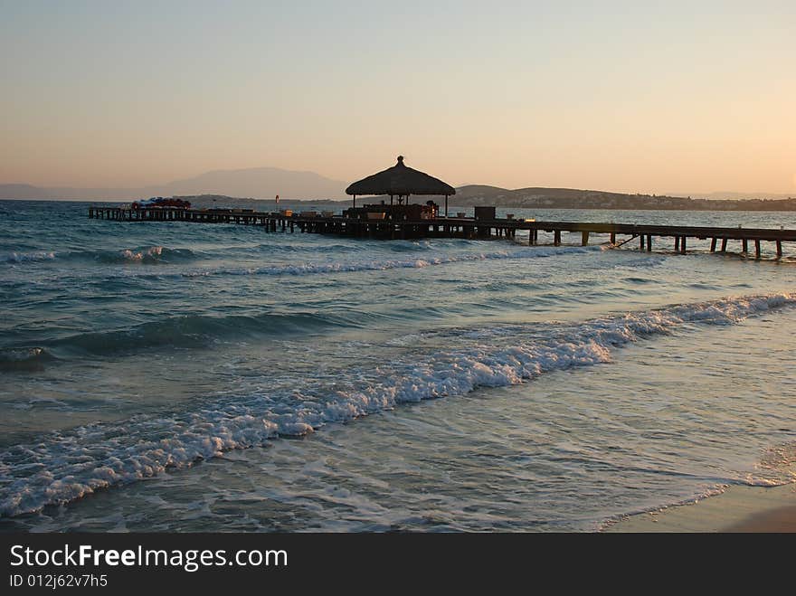 Sunrise on the beach by beach umbrellas and lounge