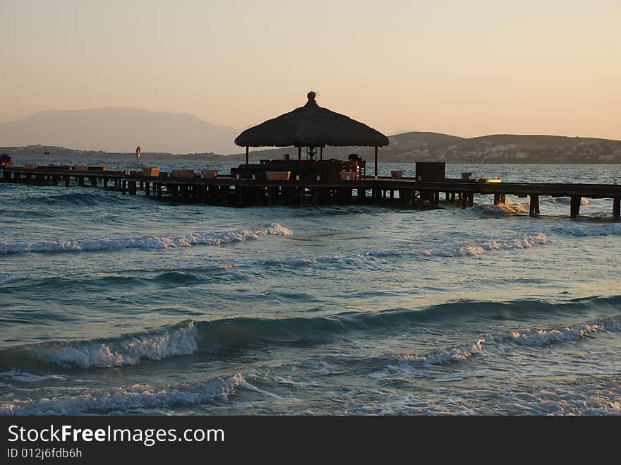 Sunrise on the beach by beach umbrellas and lounge