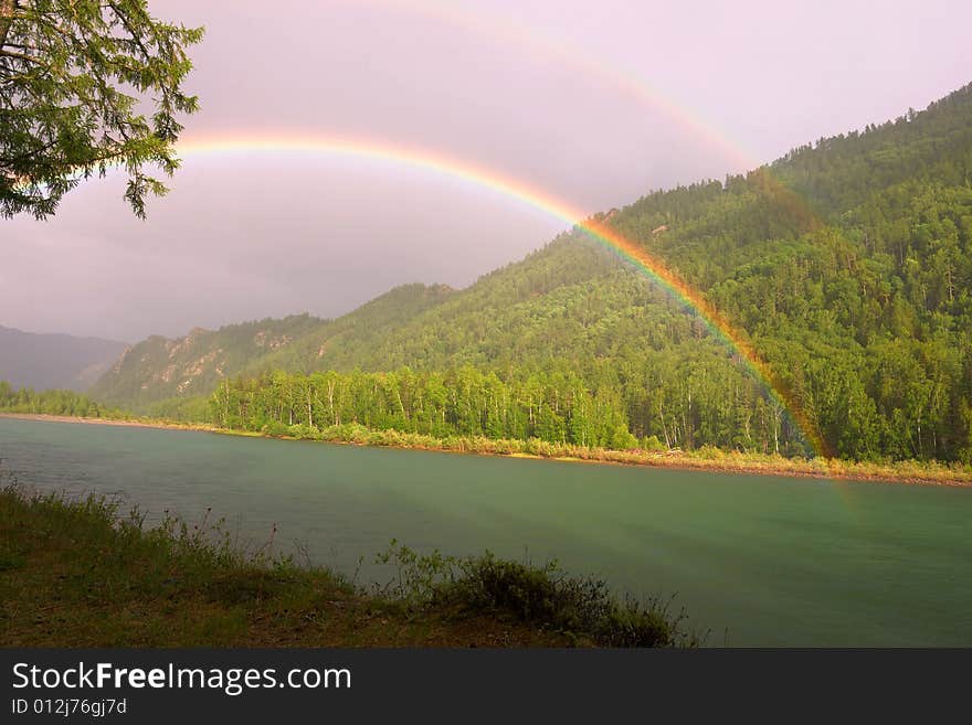 Rainbow above river in mountains