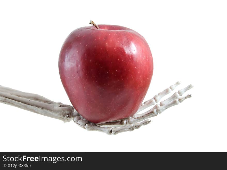 Skeleton hand holding an apple. Skeleton hand holding an apple