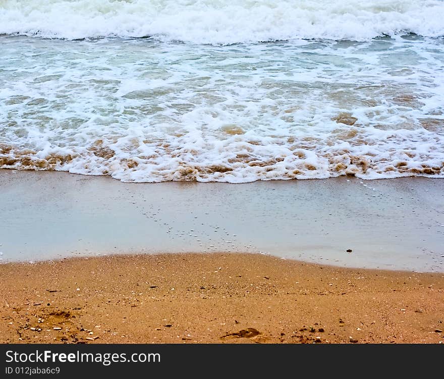 Sea wave and sand