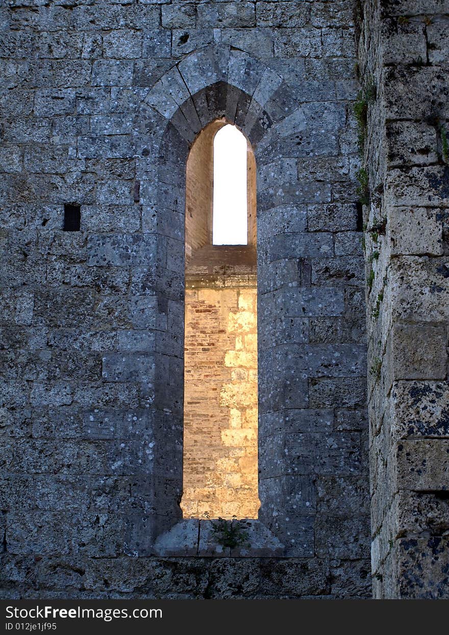 A open window in a outdoor wall of San Galgano abbey