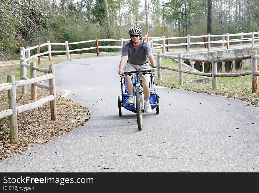 Caucasian father and son enjoying a bike ride on a country bike trail. Caucasian father and son enjoying a bike ride on a country bike trail