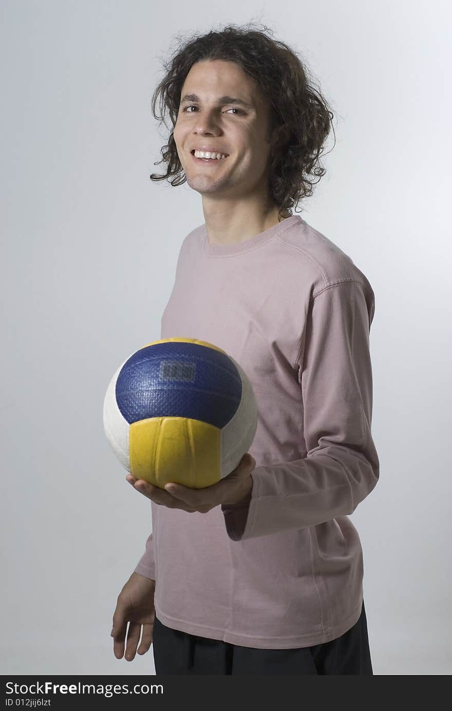 Man Posing in Studio with Volleyball - Vertical