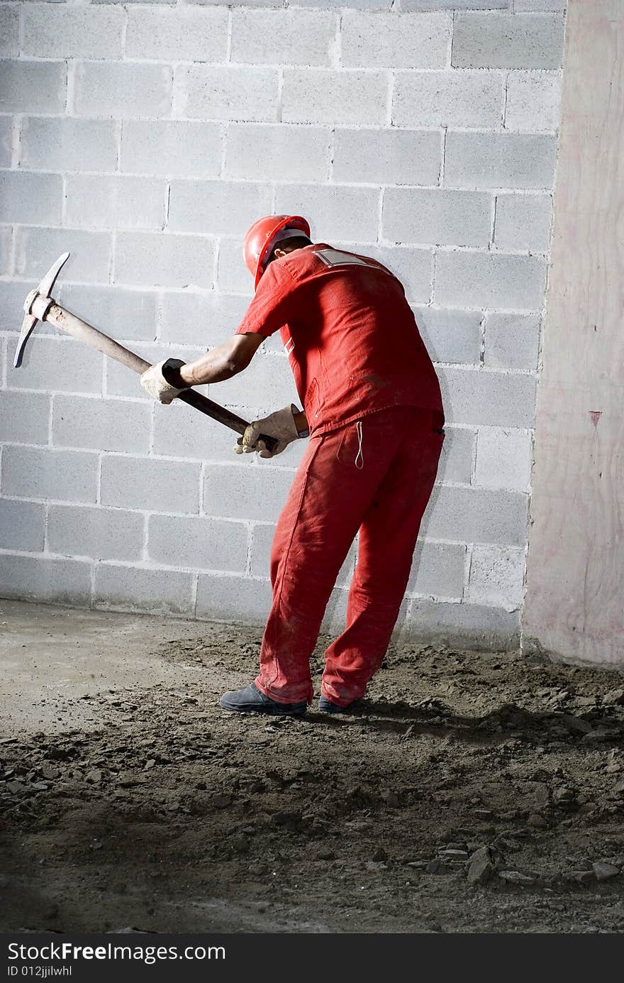 Worker Digs with Pick - Vertical