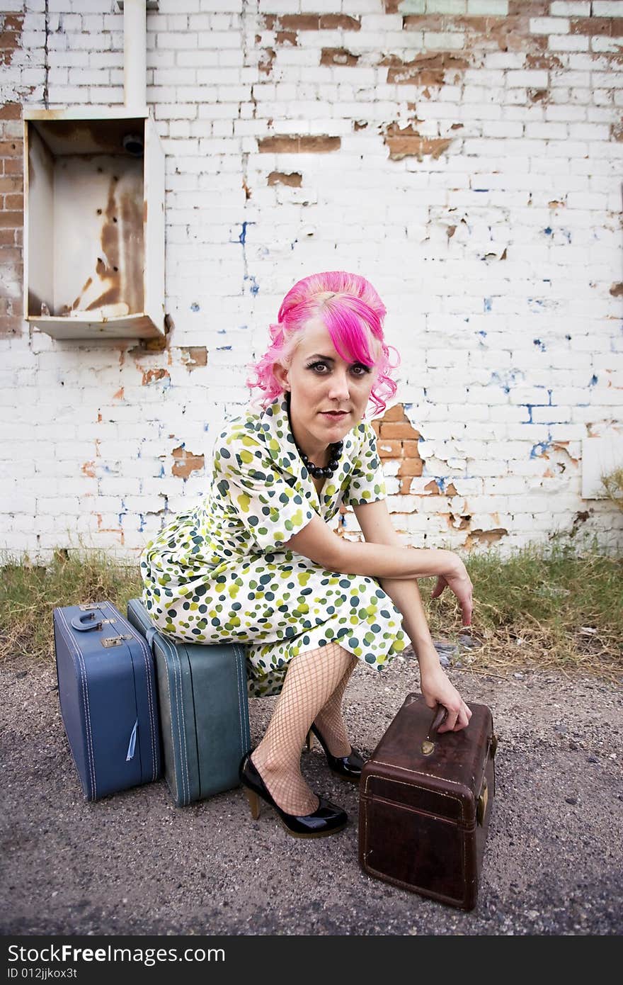 Woman with Pink Hair and a Small Suitcases