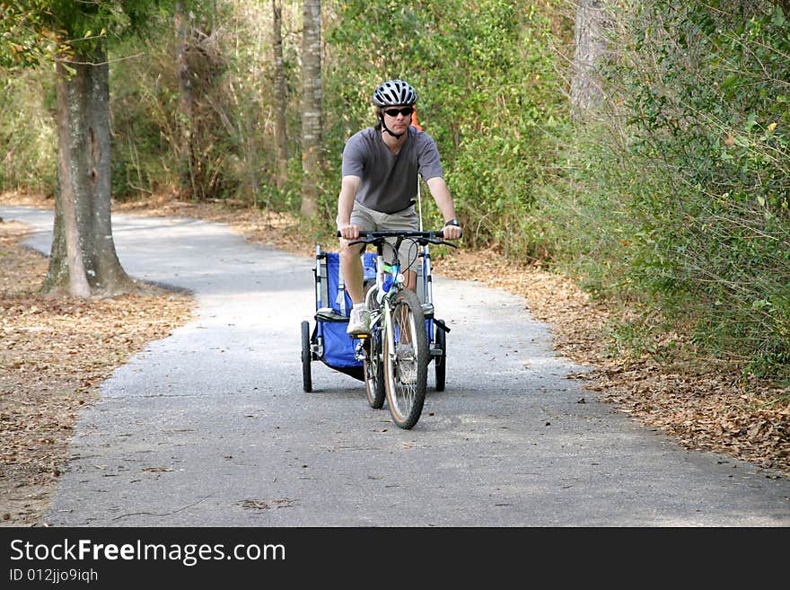 Caucasian father and son enjoying a bike ride on a country bike trail. Caucasian father and son enjoying a bike ride on a country bike trail