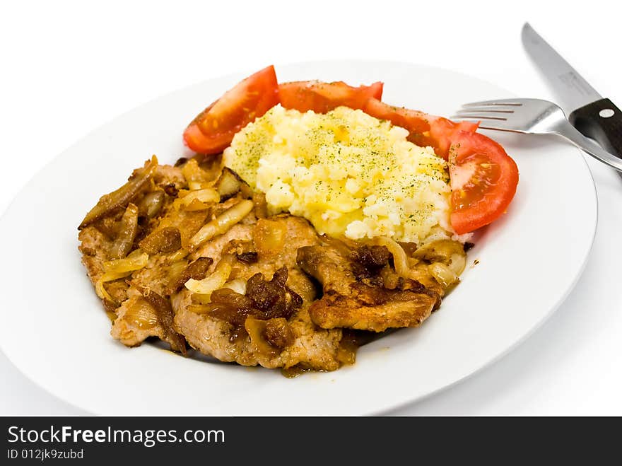 Roasted pork cutlet with puree and tomato salad