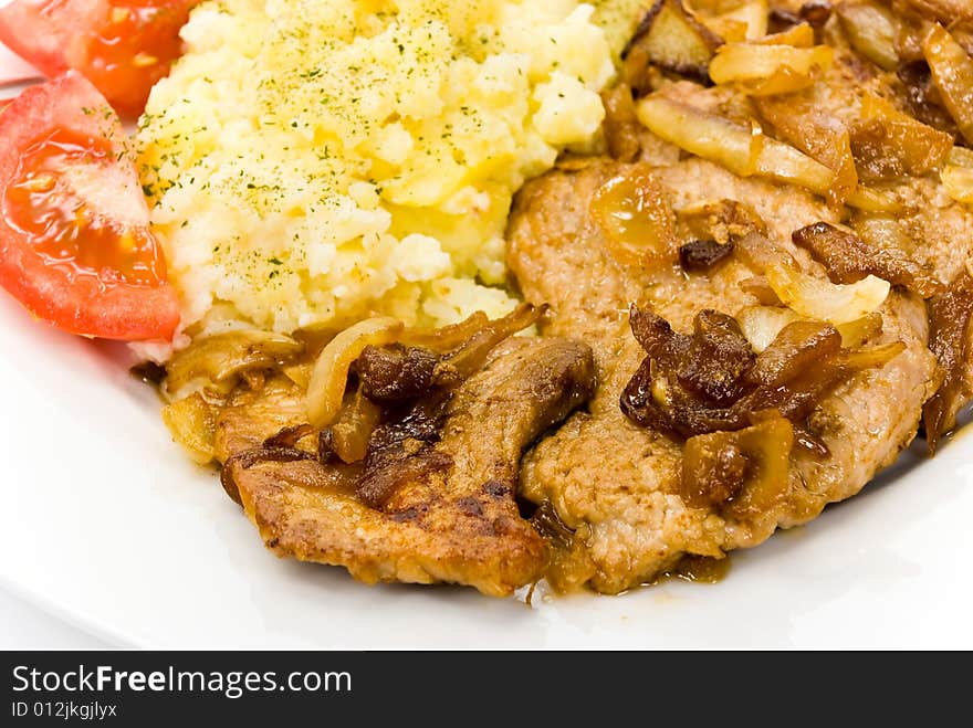 Roasted pork cutlet with puree and tomato salad