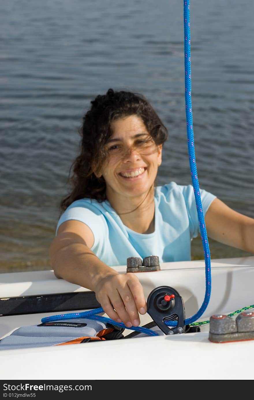 Woman Fixing Something on Boat - Vertical