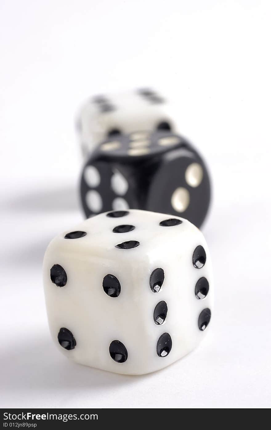 Black and white dice on a white background with selective focus. Black and white dice on a white background with selective focus