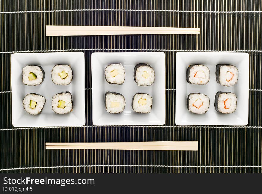 Three plates with different kinds of sushi