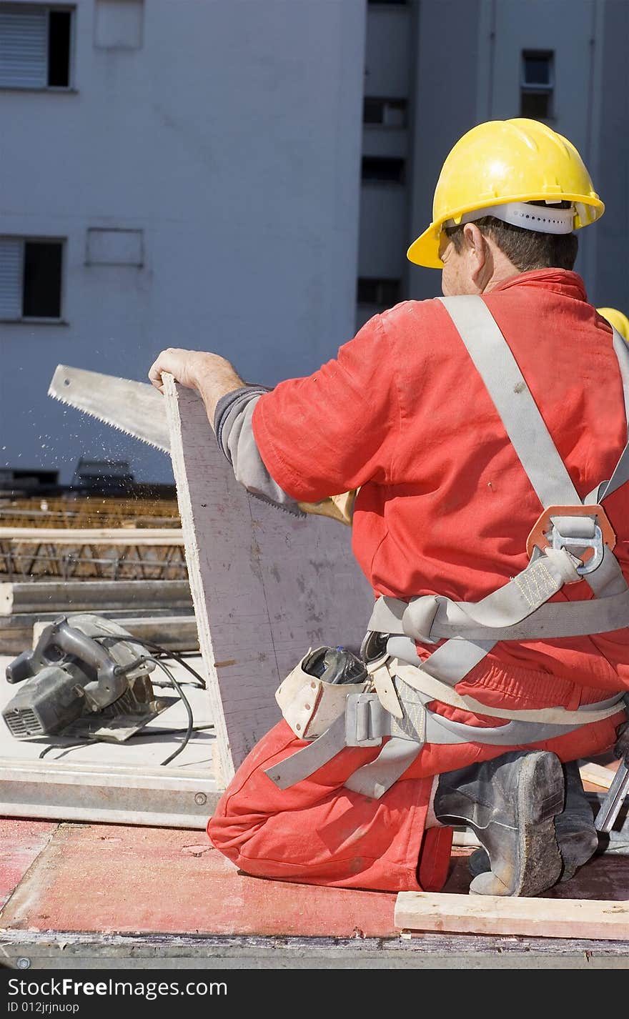 Worker Saws Board - Vertical