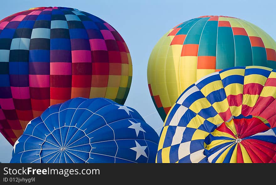 A colorful hot air balloon floating in a bright blue sky. A colorful hot air balloon floating in a bright blue sky.