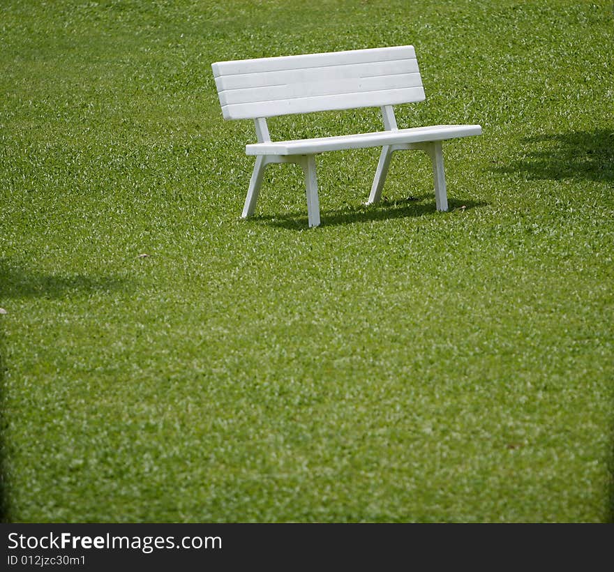 A simple picture with grass and bench. A simple picture with grass and bench